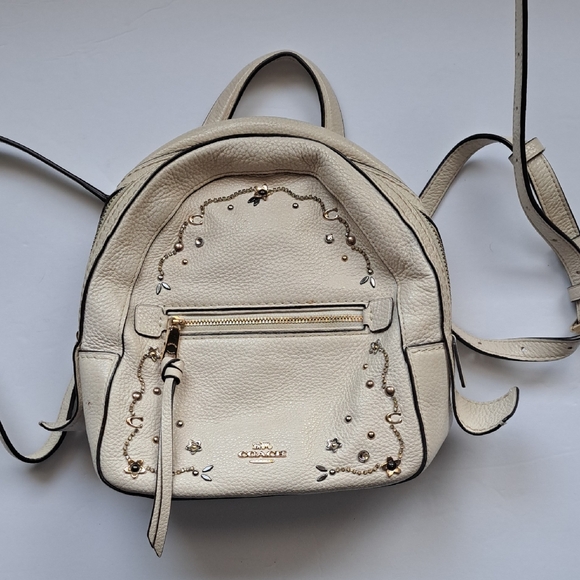 coach cream backpack purse Mini Campus in Chalk White Pebble Leather with Bandana Essex Fashion House Refined pebble leather Inside zip cell phone and multifunction pockets Laptop compartment with zip closure Zip closure recycled polyester lining Top handle with 2 drop Outside zip pockets Adjustable shoulder straps Fits a 12 (zip compartment) or 13 (main compartment) laptop 10 3/4 (L) x 14 (H) x 5 1/4 (W) Style No. Coach Cream Pebbled Leather Mini